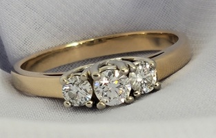 14K YELLOW GOLD THREE STONE DIAMOND RING SIZE 7.75 APPROXIMATE T.C.W. 0.46