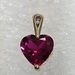 10 Karat Yellow Gold Red Gemstone Heart & A Round Clear Stone Pendant