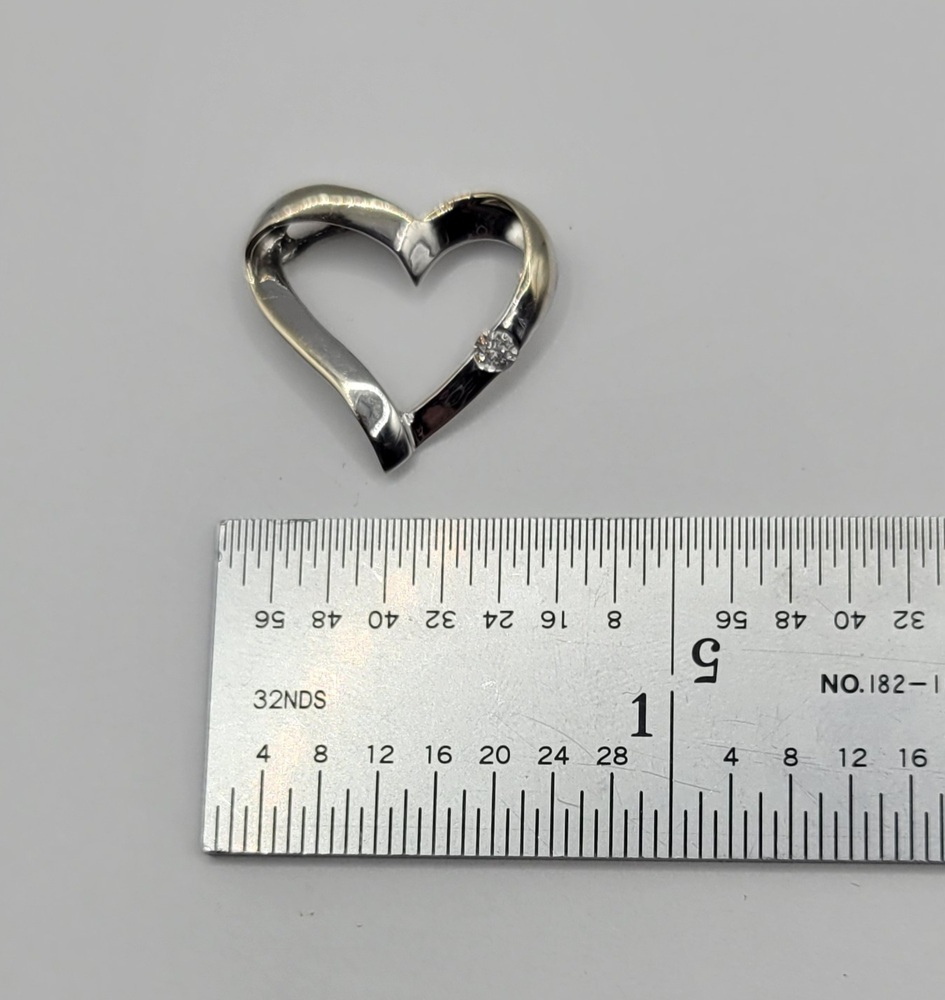 10k White Gold Diamond Open Heart Pendant Approximate t.c.w. 0.05